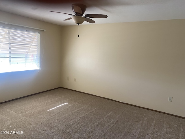 empty room featuring carpet flooring and ceiling fan