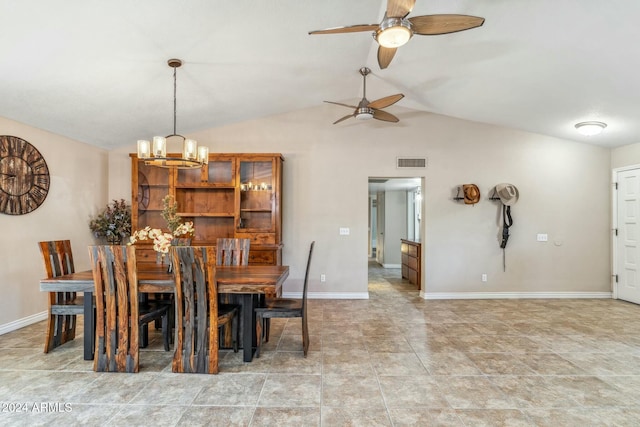 dining room featuring ceiling fan with notable chandelier and vaulted ceiling