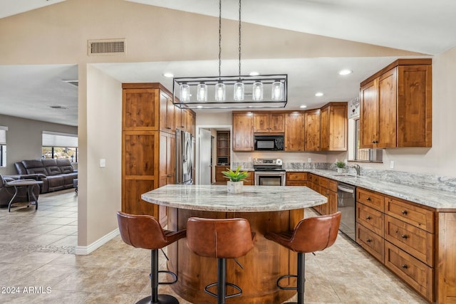 kitchen featuring stainless steel appliances, light stone counters, and lofted ceiling