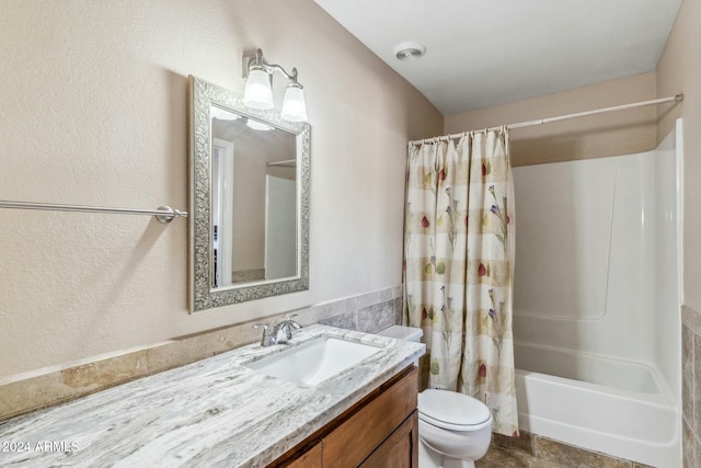 full bathroom with vanity, toilet, and shower / tub combo with curtain