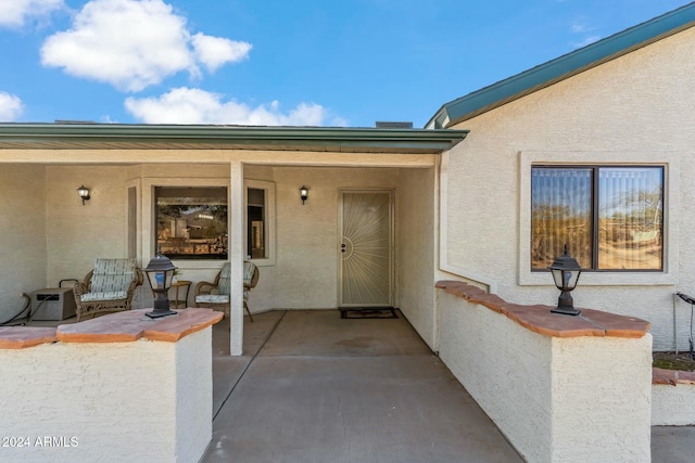 property entrance featuring a patio area