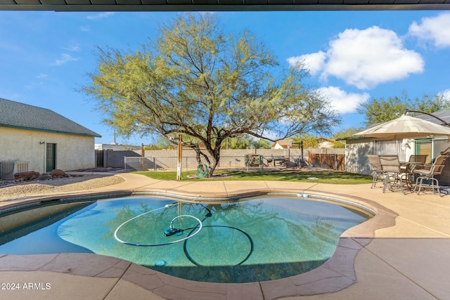 view of pool featuring central AC and a patio area