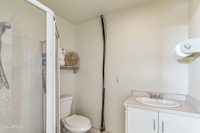 bathroom featuring vanity, an enclosed shower, and toilet