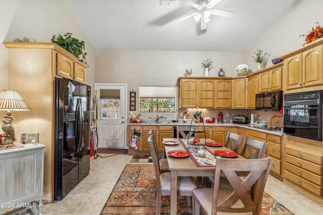 kitchen with vaulted ceiling, ceiling fan, sink, black appliances, and light tile patterned floors