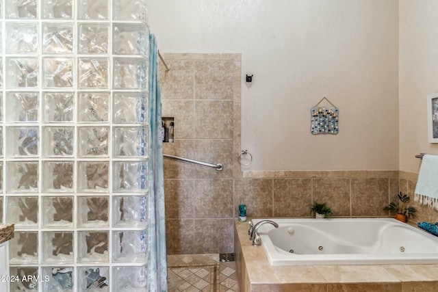 bathroom featuring independent shower and bath