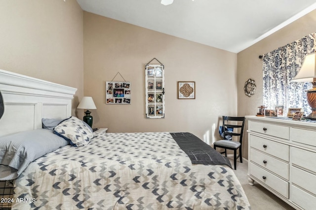 bedroom with light carpet and vaulted ceiling