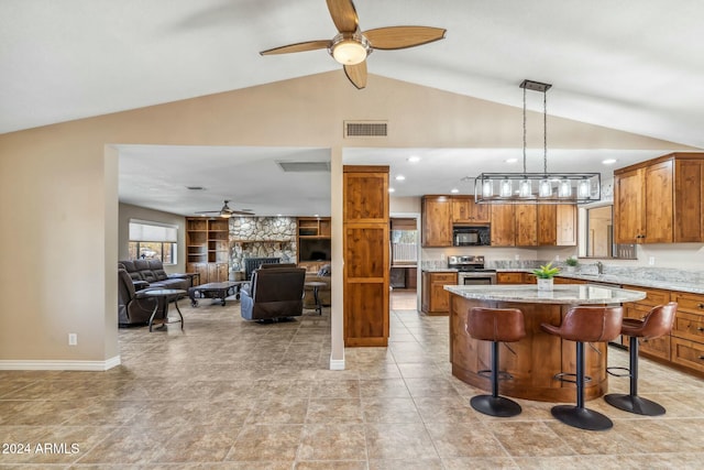 kitchen with a breakfast bar, vaulted ceiling, a kitchen island, sink, and stainless steel electric range oven