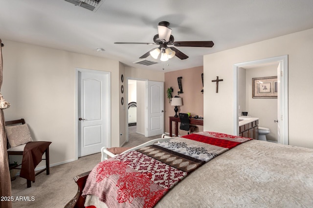 carpeted bedroom featuring ensuite bath and ceiling fan