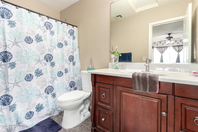 bathroom with tile patterned flooring, vanity, ceiling fan, and toilet