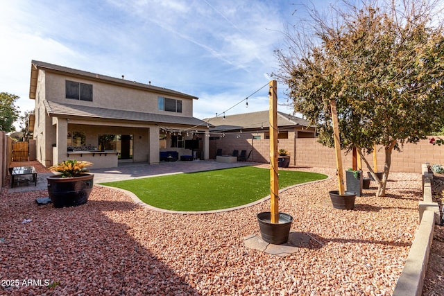 rear view of property featuring a patio, area for grilling, and a lawn