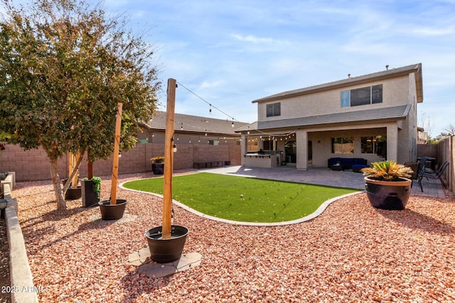 back of house with a yard, a patio, and exterior kitchen