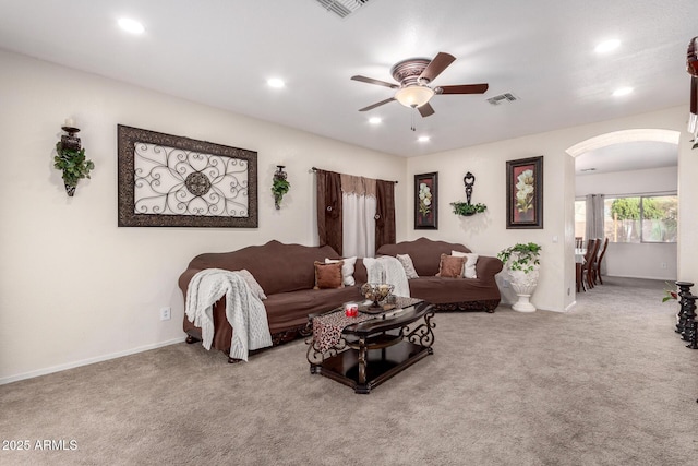 living room featuring carpet and ceiling fan