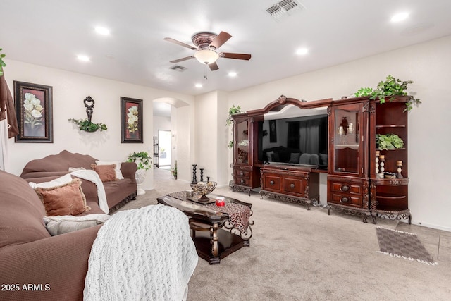 living room with ceiling fan and light colored carpet