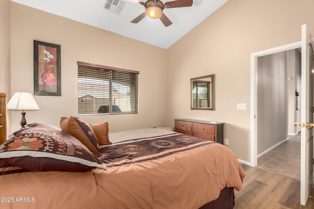 bedroom with lofted ceiling, light hardwood / wood-style floors, and ceiling fan