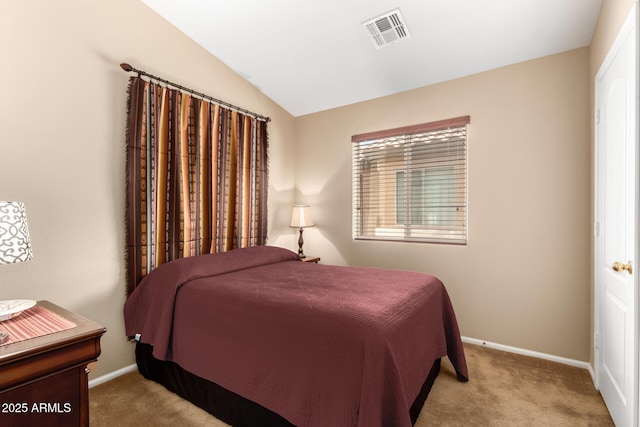 bedroom with lofted ceiling and light colored carpet