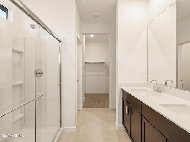 3550 N Camden Dr, Florence, AZ 85132 - full bathroom featuring a stall shower, double vanity, a spacious closet, and tile patterned flooring