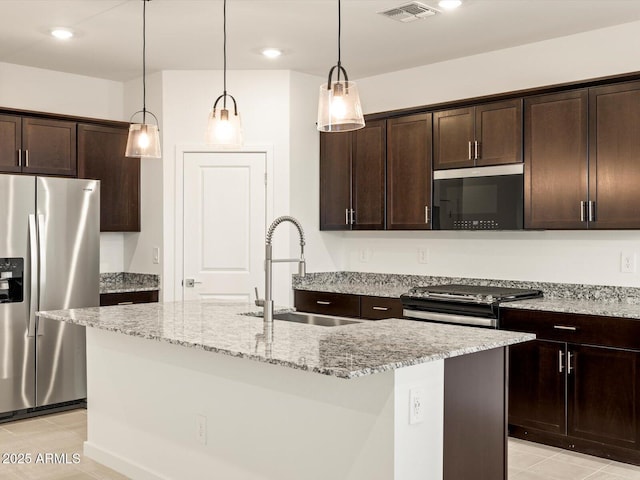 3550 N Camden Dr, Florence, AZ 85132 - kitchen with appliances with stainless steel finishes, dark brown cabinetry, light stone countertops, light tile patterned flooring, and hanging light fixtures