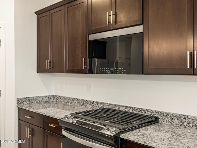 3550 N Camden Dr, Florence, AZ 85132 - kitchen featuring stainless steel range with gas cooktop, dark brown cabinets, and light stone countertops