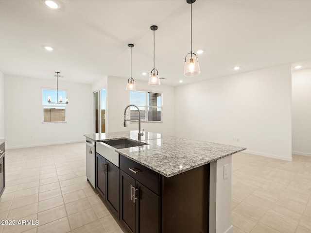 3550 N Camden Dr, Florence, AZ 85132 - kitchen featuring a chandelier, recessed lighting, light stone counters, an island with sink, and pendant lighting