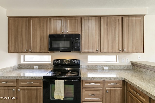1072 W Windhaven Ave, Gilbert, AZ 85233 - kitchen with black appliances, brown cabinetry, and light stone counters