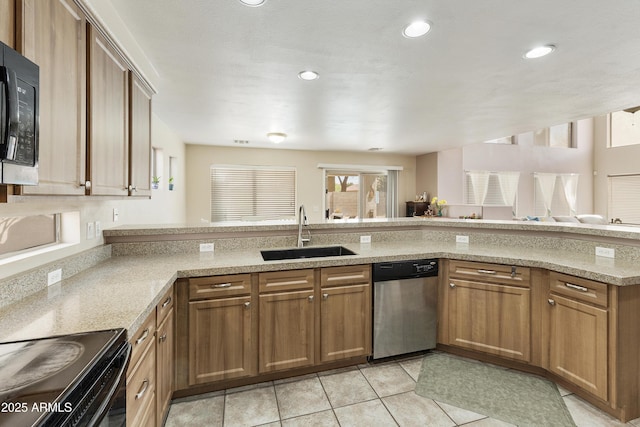 1072 W Windhaven Ave, Gilbert, AZ 85233 - kitchen with black appliances, a sink, light stone counters, light tile patterned floors, and brown cabinets