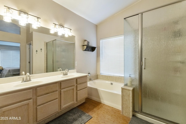 1072 W Windhaven Ave, Gilbert, AZ 85233 - full bathroom featuring a stall shower, a bath, wood finished floors, double vanity, and lofted ceiling