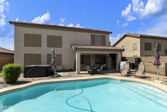 1072 W Windhaven Ave, Gilbert, AZ 85233 - rear view of property featuring a hot tub, stucco siding, a patio area, and a tile roof