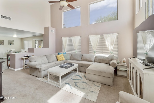 1072 W Windhaven Ave, Gilbert, AZ 85233 - living room with light carpet, a ceiling fan, and a towering ceiling