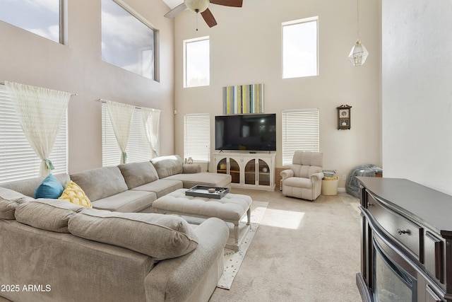 1072 W Windhaven Ave, Gilbert, AZ 85233 - living room featuring a high ceiling, ceiling fan, and light carpet