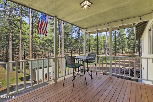 3017 Larson Loop, Forest Lakes, AZ 85931 - wooden deck featuring view of wooded area and outdoor dining space