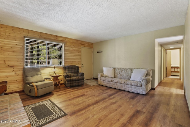 3017 Larson Loop, Forest Lakes, AZ 85931 - living room with a textured ceiling, wood finished floors, and wooden walls