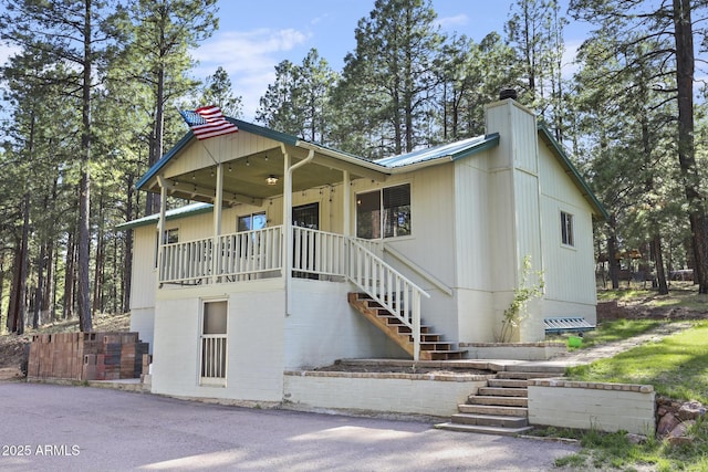 3017 Larson Loop, Forest Lakes, AZ 85931 - view of front of property featuring stairway, metal roof, ceiling fan, and a chimney