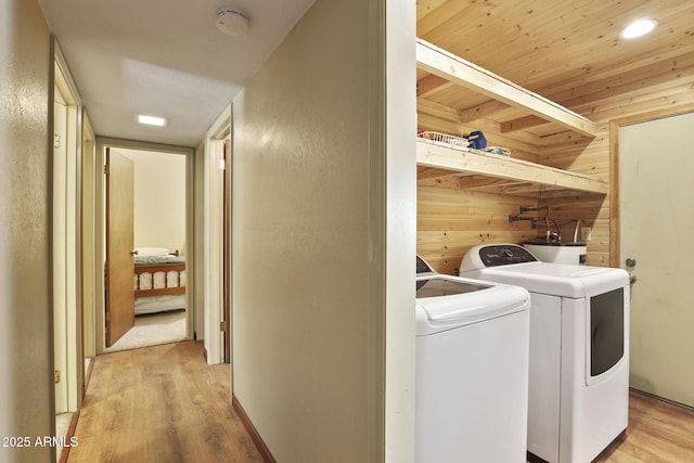 3017 Larson Loop, Forest Lakes, AZ 85931 - washroom featuring light wood-style floors, wooden walls, separate washer and dryer, and water heater