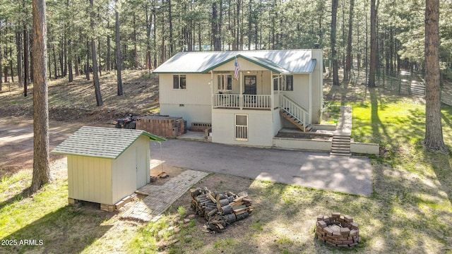3017 Larson Loop, Forest Lakes, AZ 85931 - view of shed featuring a fire pit, stairway, and a forest view
