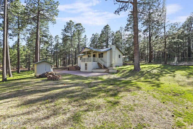 3017 Larson Loop, Forest Lakes, AZ 85931 - view of yard featuring a storage shed, an outbuilding, a patio area, stairs, and view of scattered trees