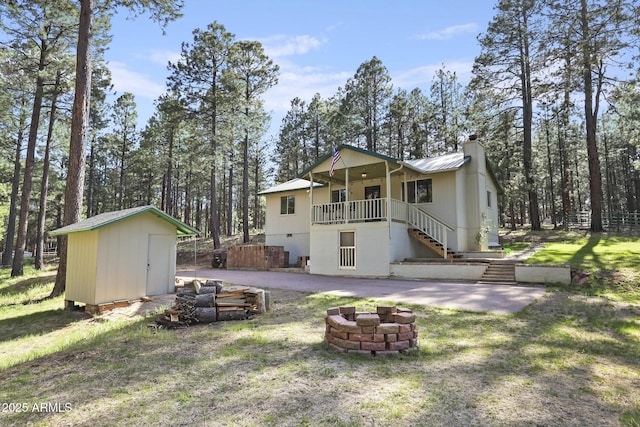3017 Larson Loop, Forest Lakes, AZ 85931 - rear view of property with stairs, a fire pit, a storage unit, a chimney, and an outbuilding