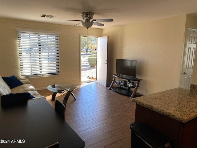 living room with hardwood / wood-style flooring and ceiling fan