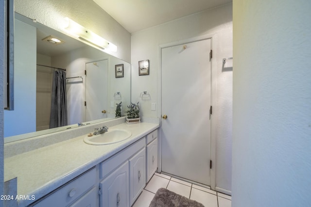 bathroom featuring a shower with curtain, vanity, and tile patterned floors