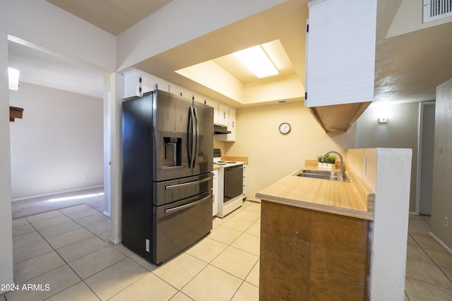 kitchen with stainless steel fridge, sink, white cabinets, white range with electric cooktop, and light tile patterned flooring