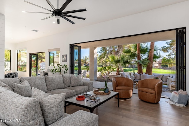 living room with hardwood / wood-style flooring and ceiling fan