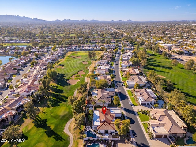 birds eye view of property with a water and mountain view