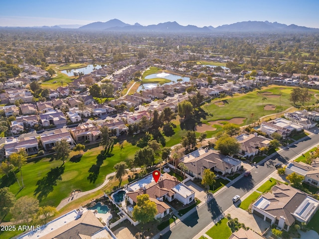 birds eye view of property with a water and mountain view