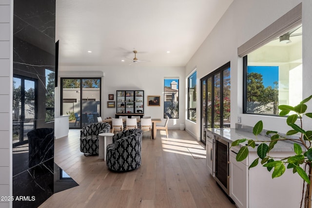 living room featuring ceiling fan and light hardwood / wood-style floors