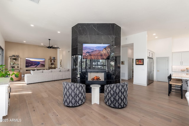 living room featuring ceiling fan and light wood-type flooring