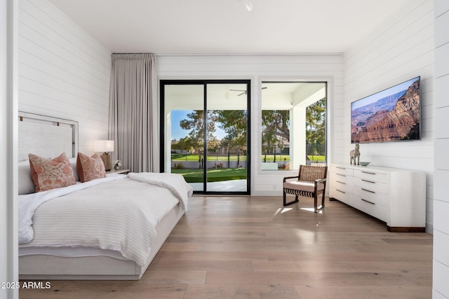 bedroom featuring access to outside and hardwood / wood-style floors