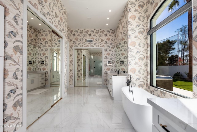 bathroom with plenty of natural light, vanity, and independent shower and bath