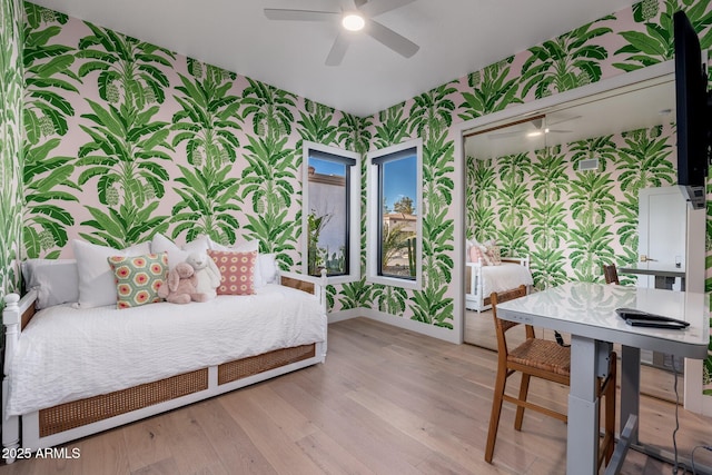 bedroom featuring ceiling fan, a closet, and light hardwood / wood-style floors