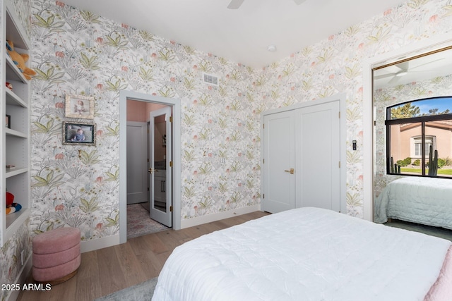 bedroom with ceiling fan, light hardwood / wood-style floors, and a closet