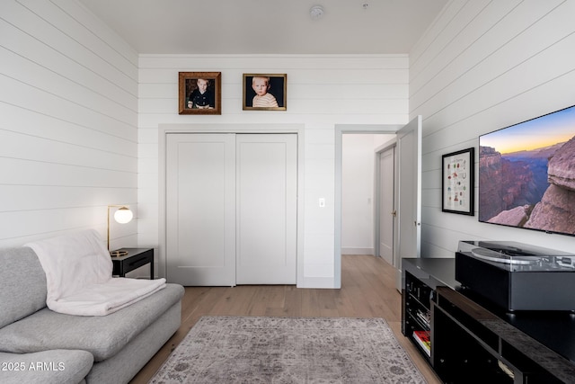 interior space with wood walls and light hardwood / wood-style floors