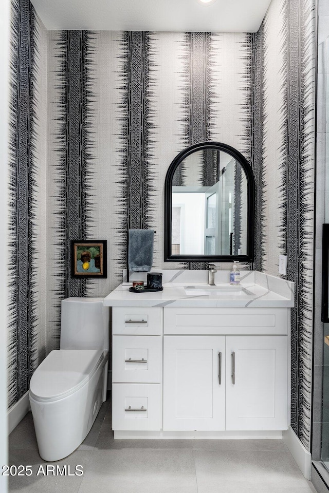 bathroom featuring tile patterned floors, vanity, and toilet